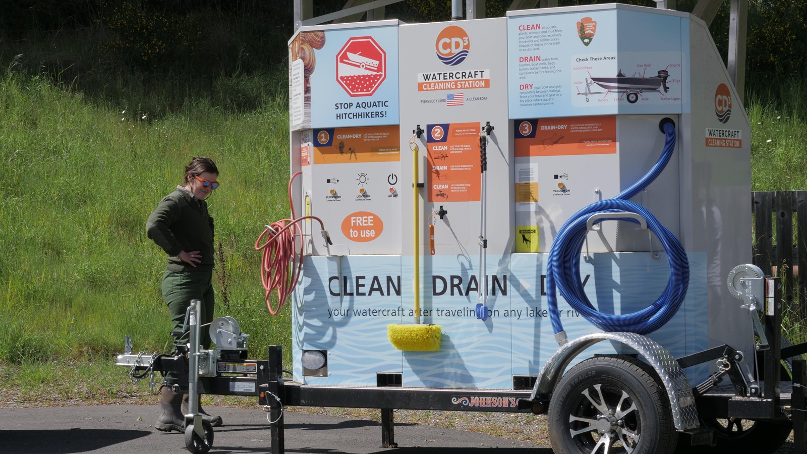 A small trailer with hoses and brushes and the words