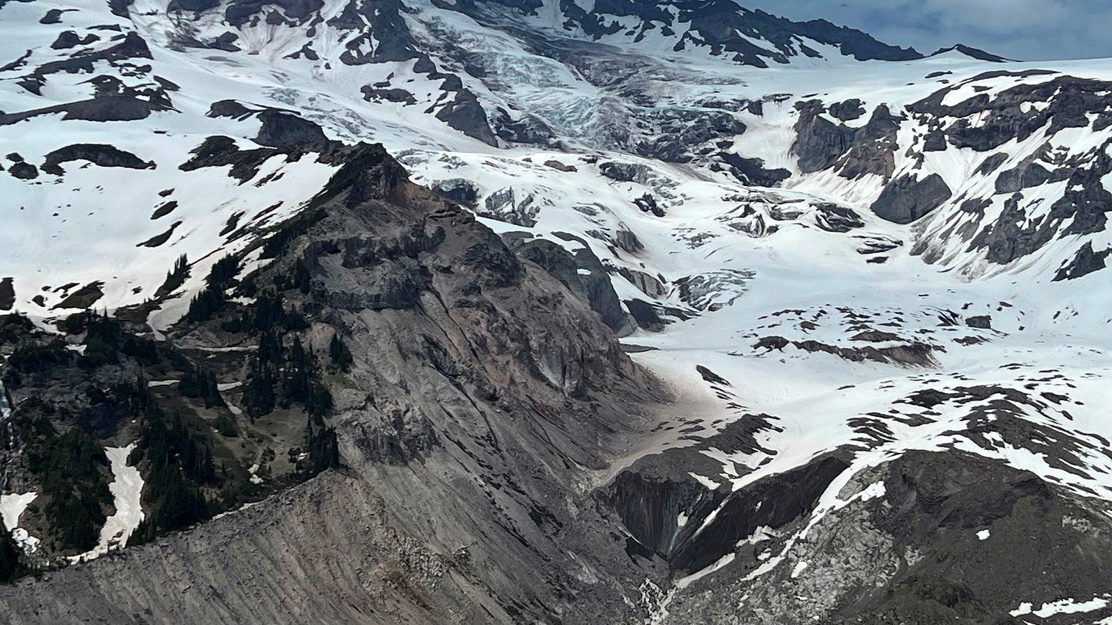 Retreating glacier on southwest side of mountain forming a river