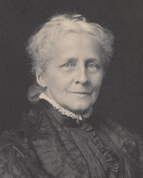 black and white photograph of elderly woman with white hair and black blouse