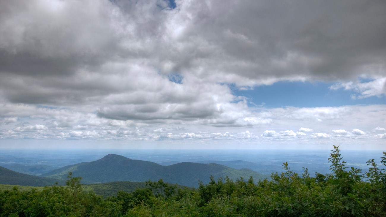 A view from on top of the summit of a mountain.