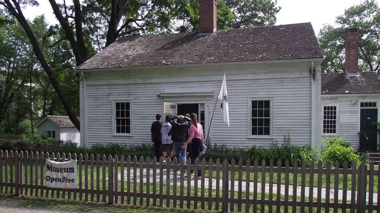 White building with visitors entering the front door