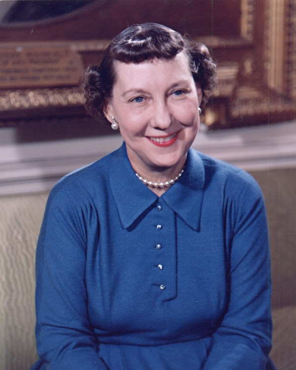 a portrait photo of a woman in a blue dress