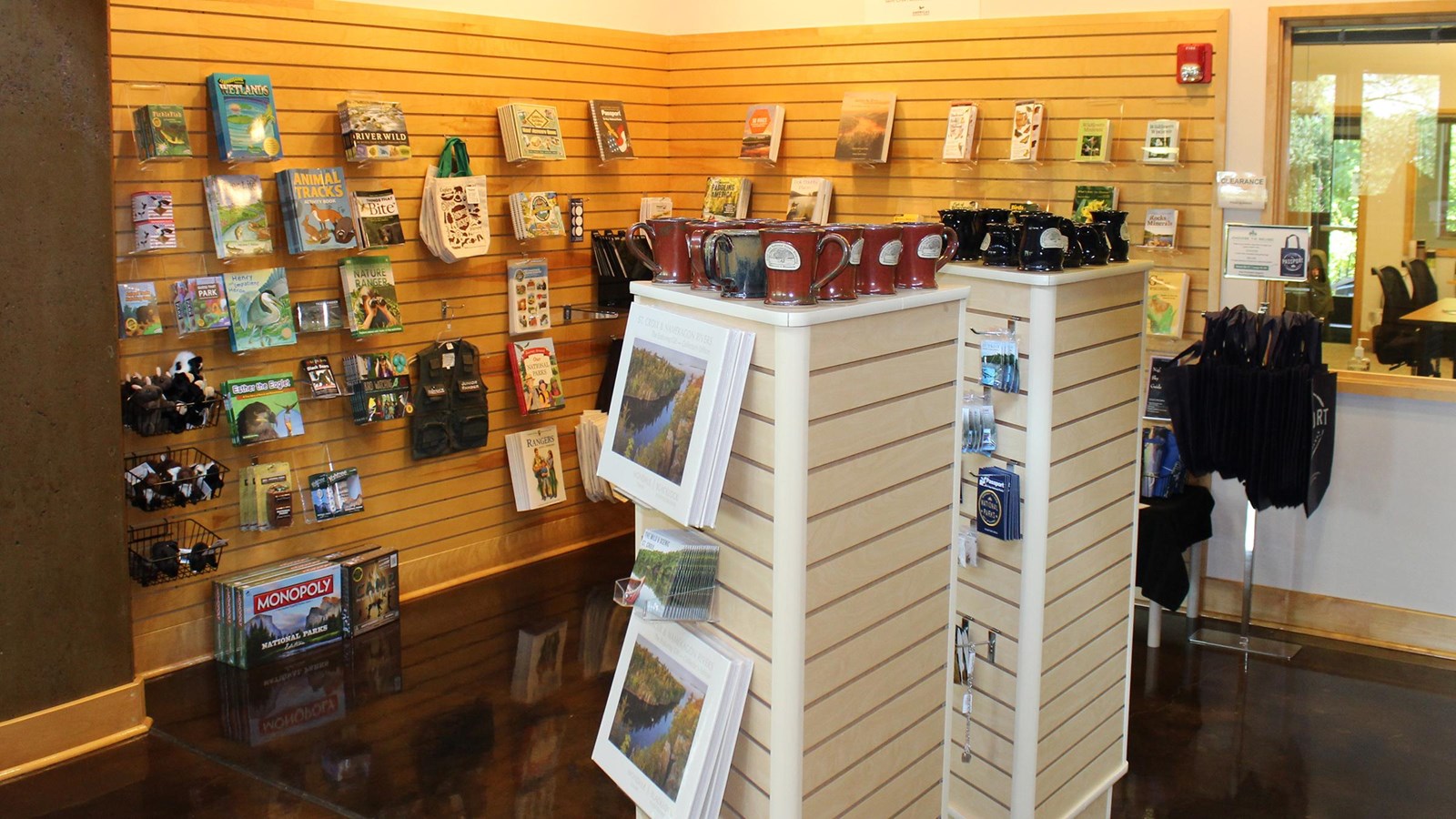 Sales items neatly displayed on a rack under lights inside a building.  