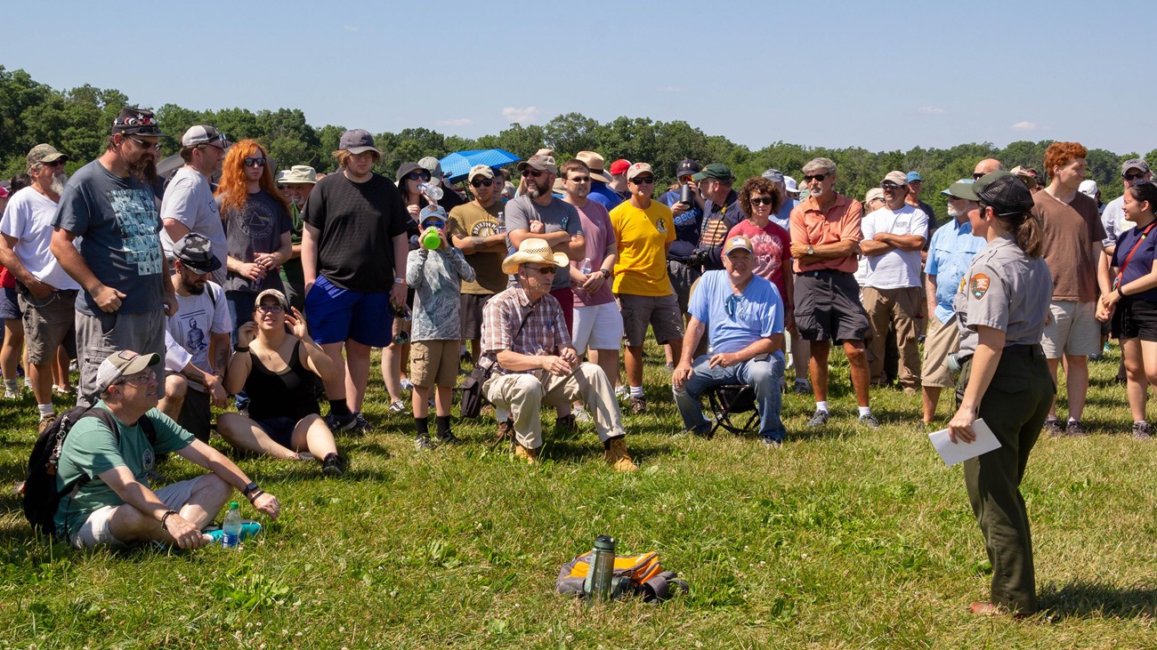 A park ranger gives a program to a group of people.