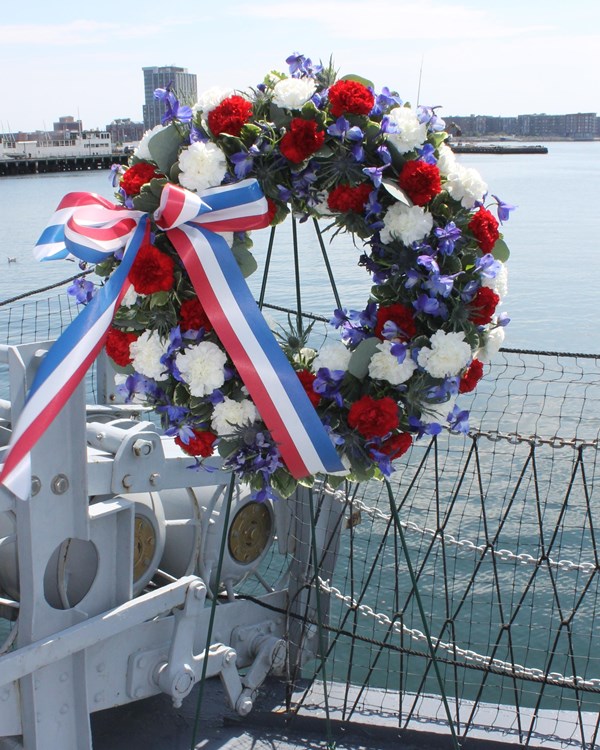 Wreath decorated in red, white, and blue flowers. 