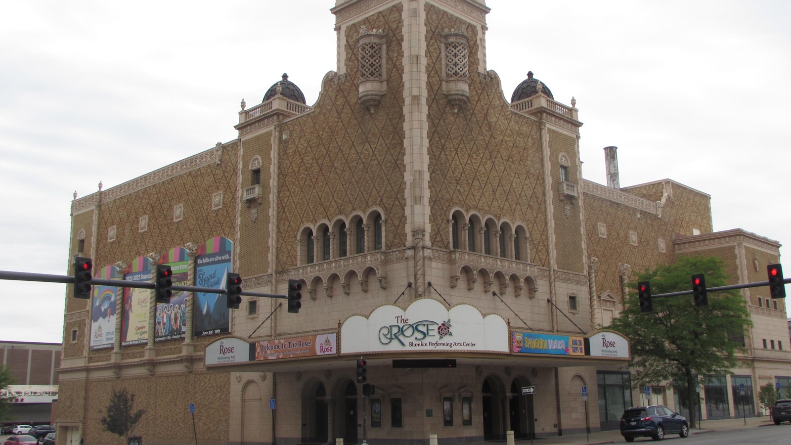 Corner theater building with large Moorish tower. Entrance located at corner of building.
