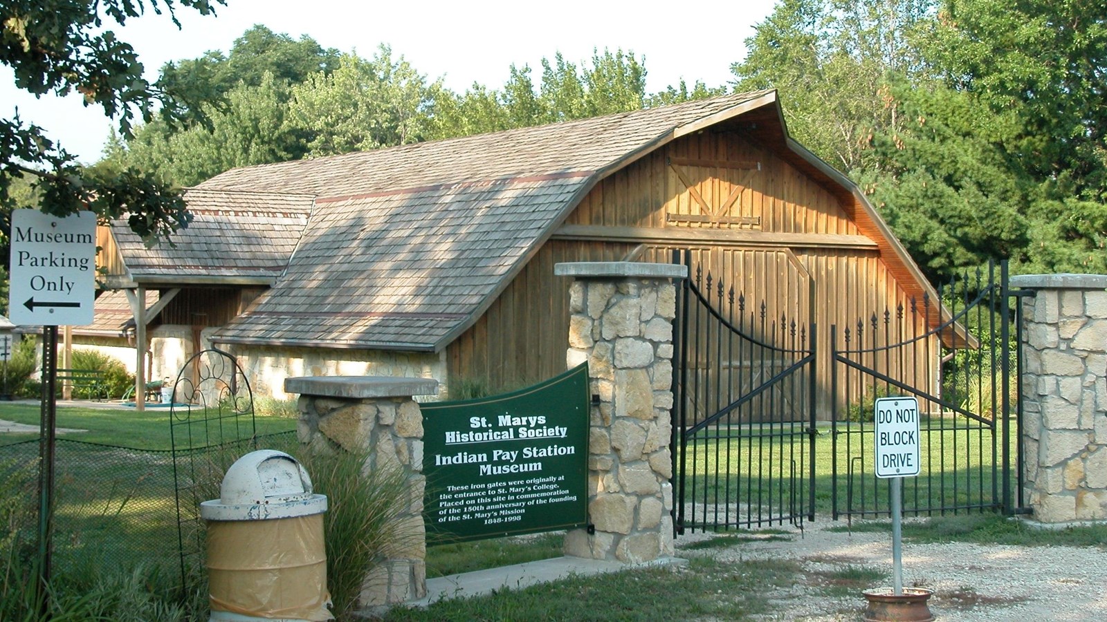 The stone wall and metal fence around the entrance to St. Mary\'s Mission Museum.