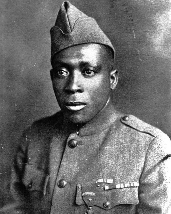 Black and White photo of African American man in World War One uniform from the chest up.