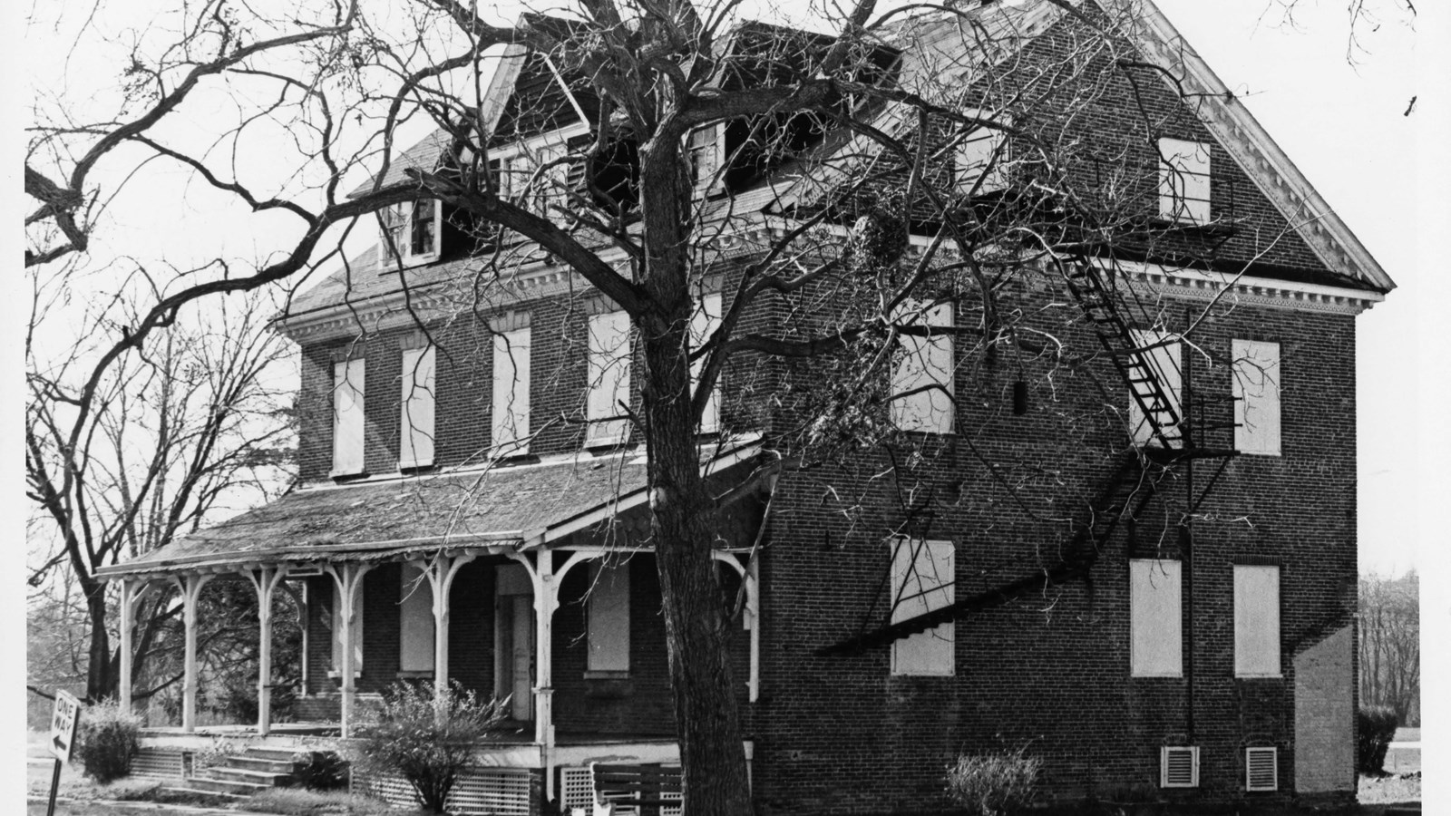 Three story brick building with porch