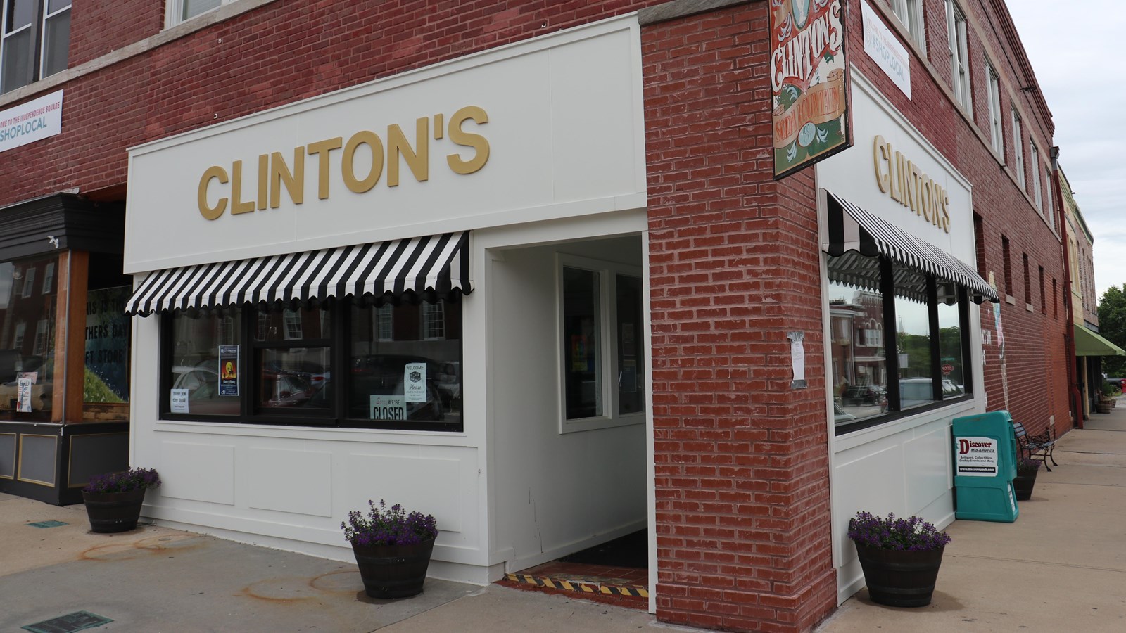 Clinton\'s Drugstore white and brick building store front.