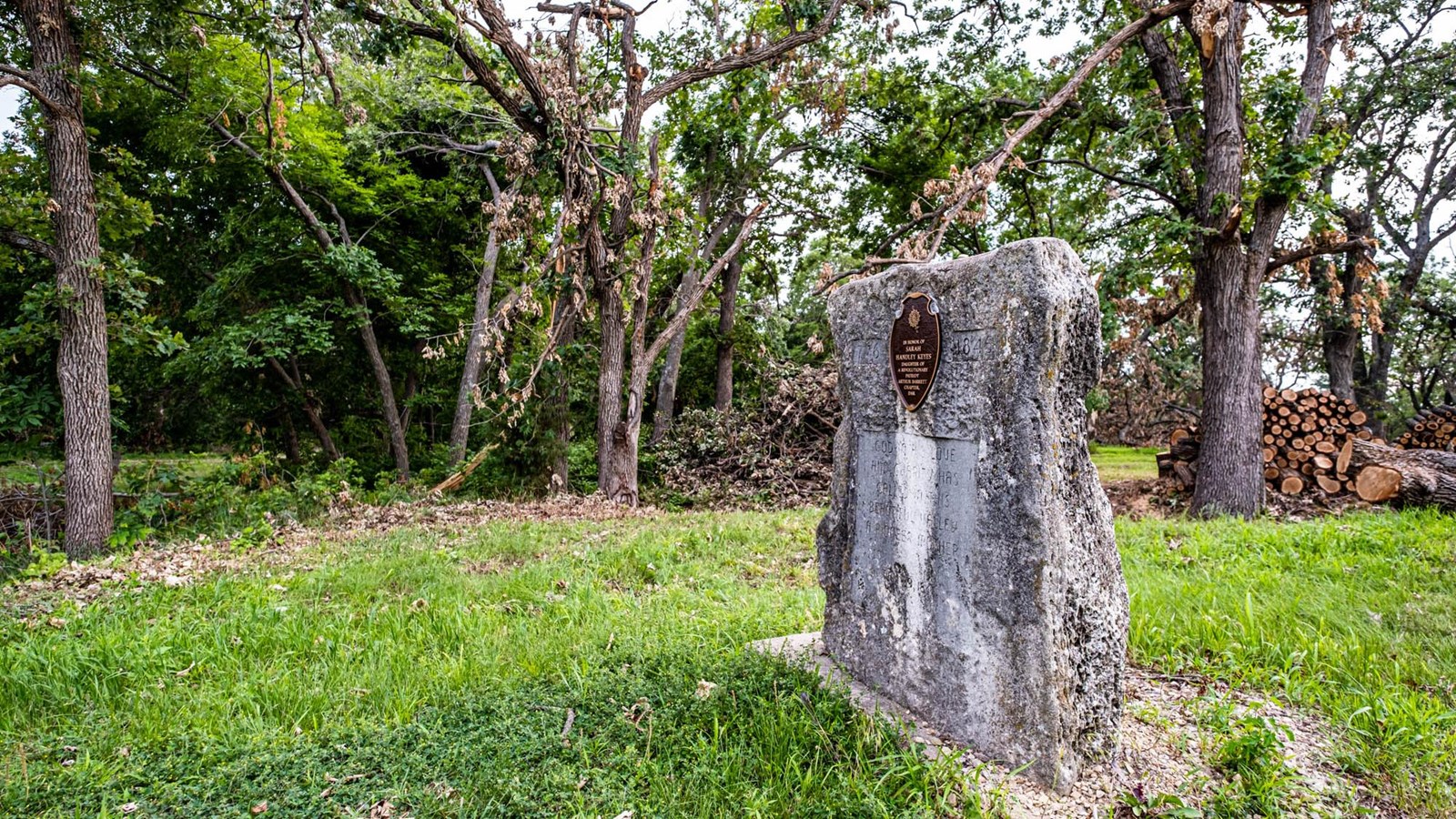 A stone marker in a grassy area.