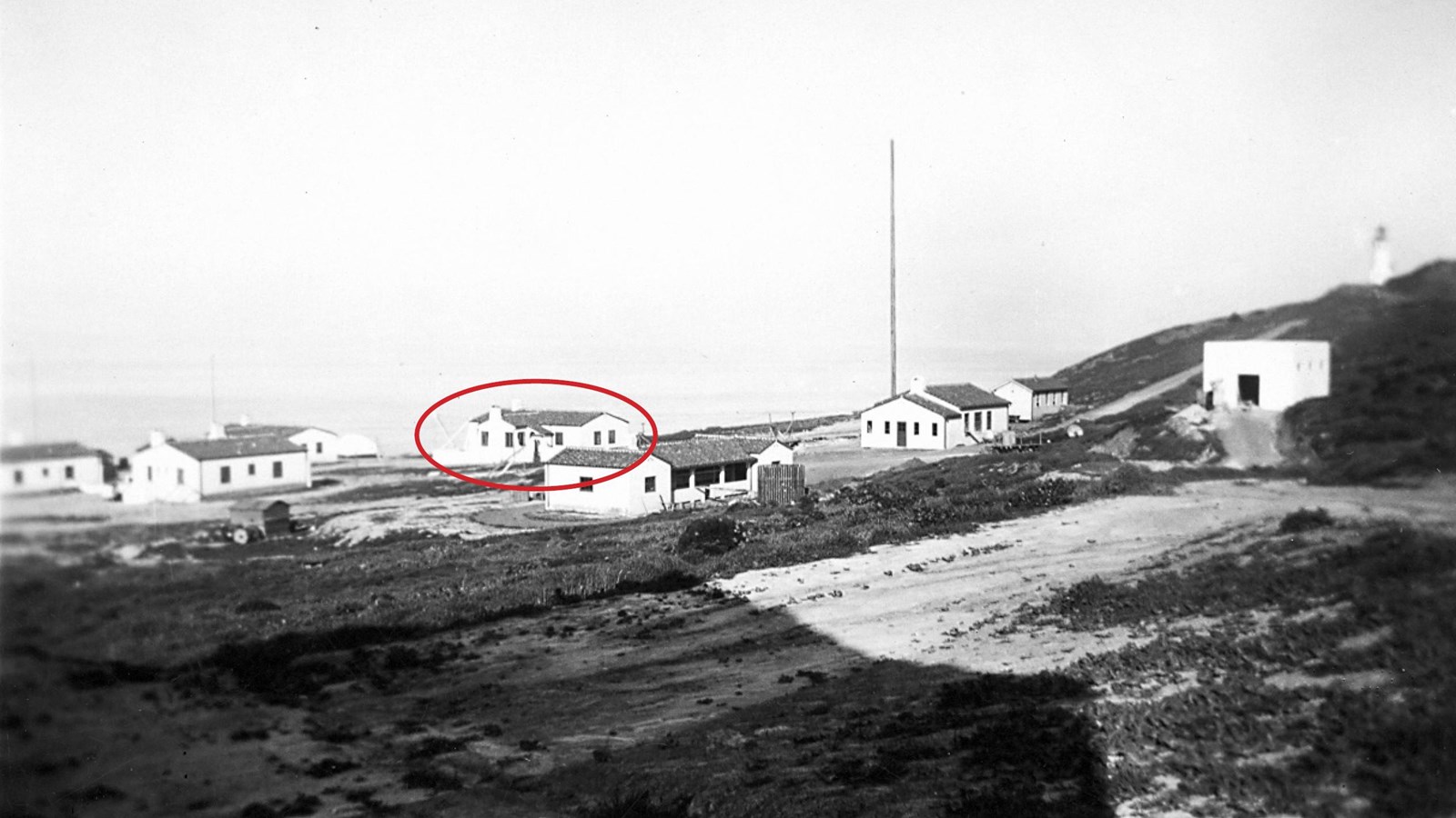 Historic photo lighthouse complex buildings. White buildings with red roofs.