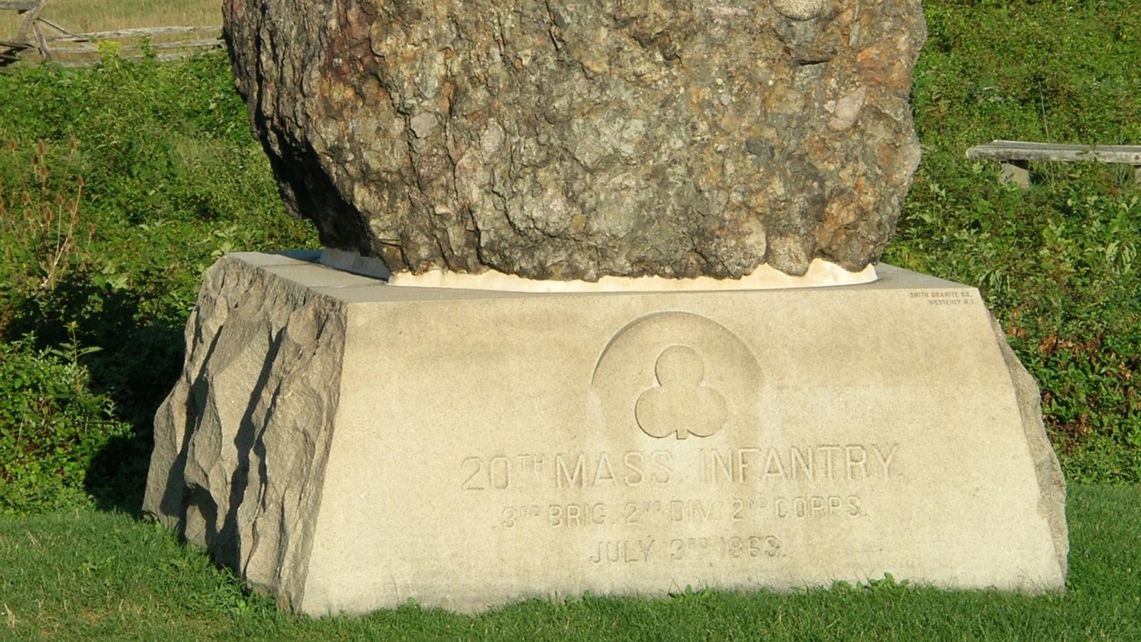 A large boulder on a granite pedestal 