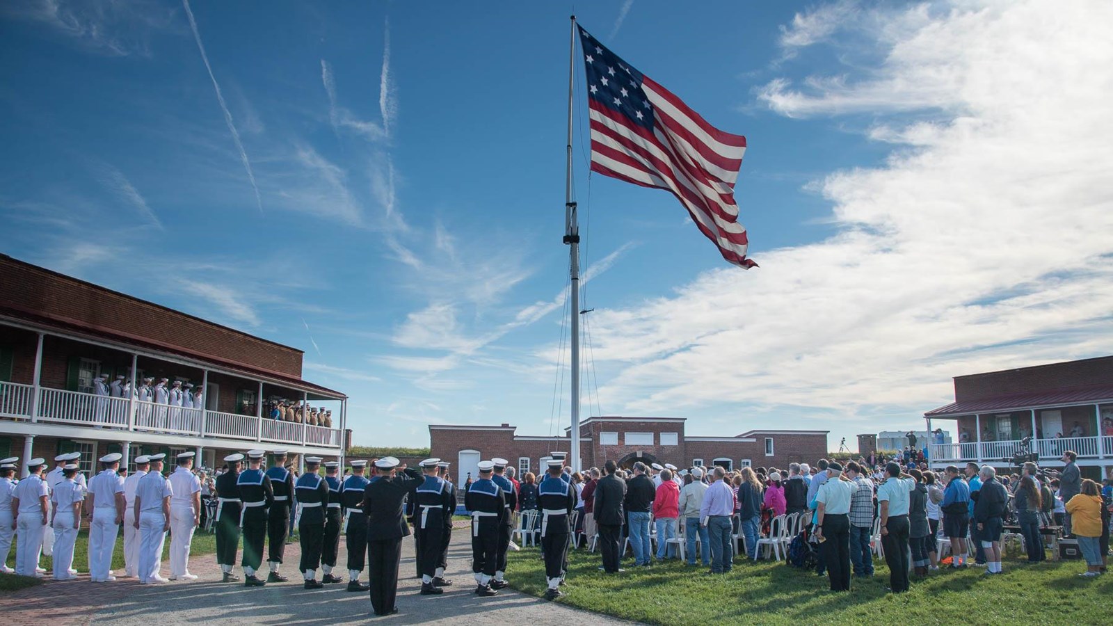 A modern day image showing a crowd inside the star fort with the large garrison flag flying above.