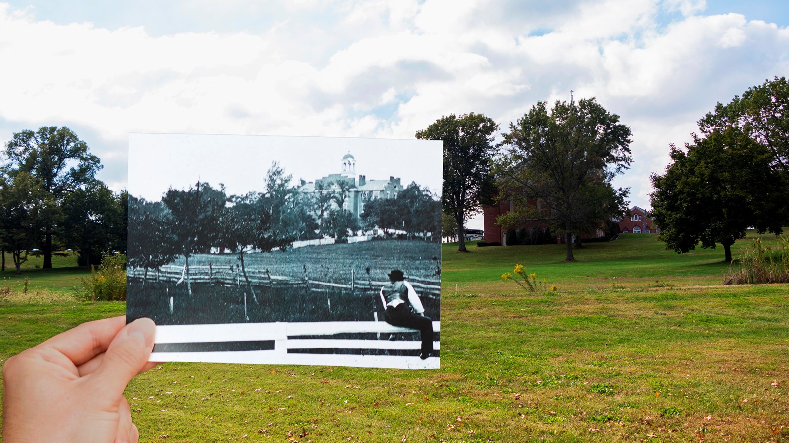 A historic image being held up against the modern location of the Lutheran Seminary.