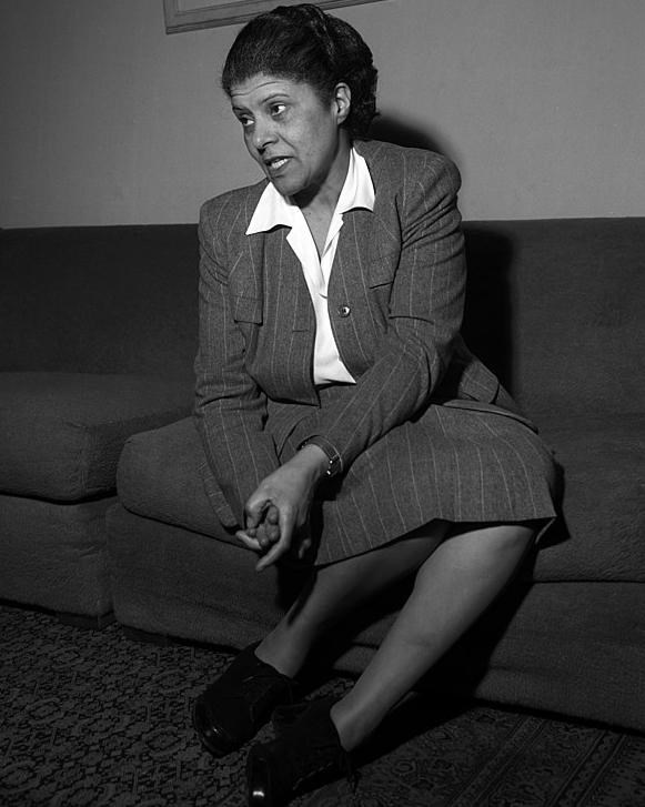 Eslanda Goode Robeson, a Black woman wearing a striped skirt suit and a white blouse.