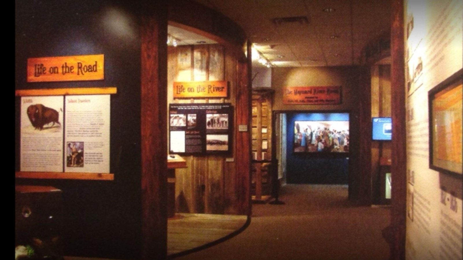 A hallway lined with wall exhibits and glass cases with historic information.