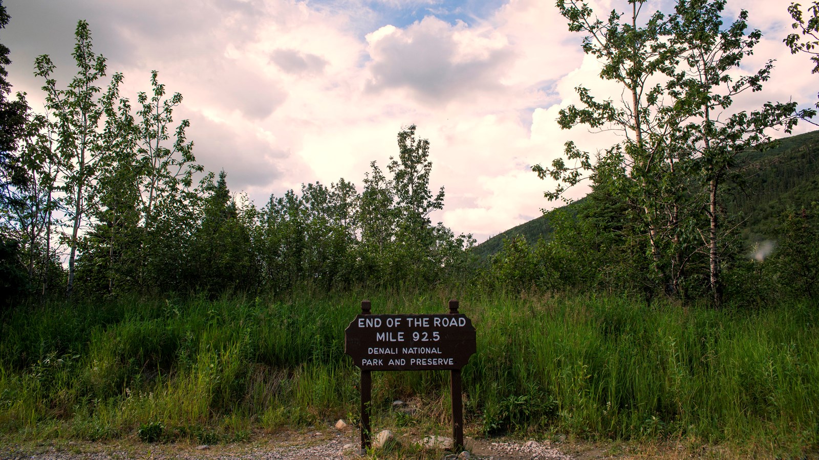 a small wooden sign reading \'end of the denali park road, kantishna, mile 92