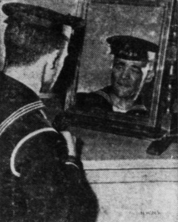 Portrait of George Fields in naval uniform looking in a mirror.