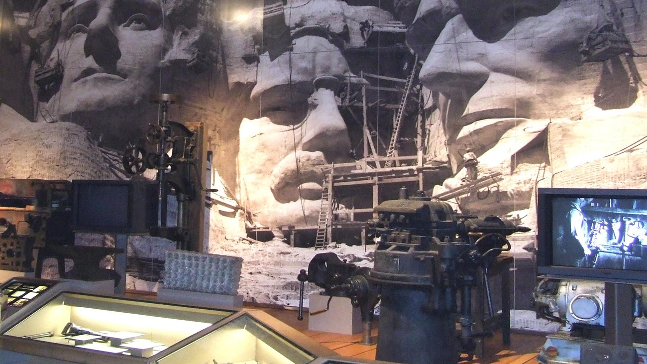 Photo of exhibits inside the Lincoln Borglum Visitor Center showing tools and photos.