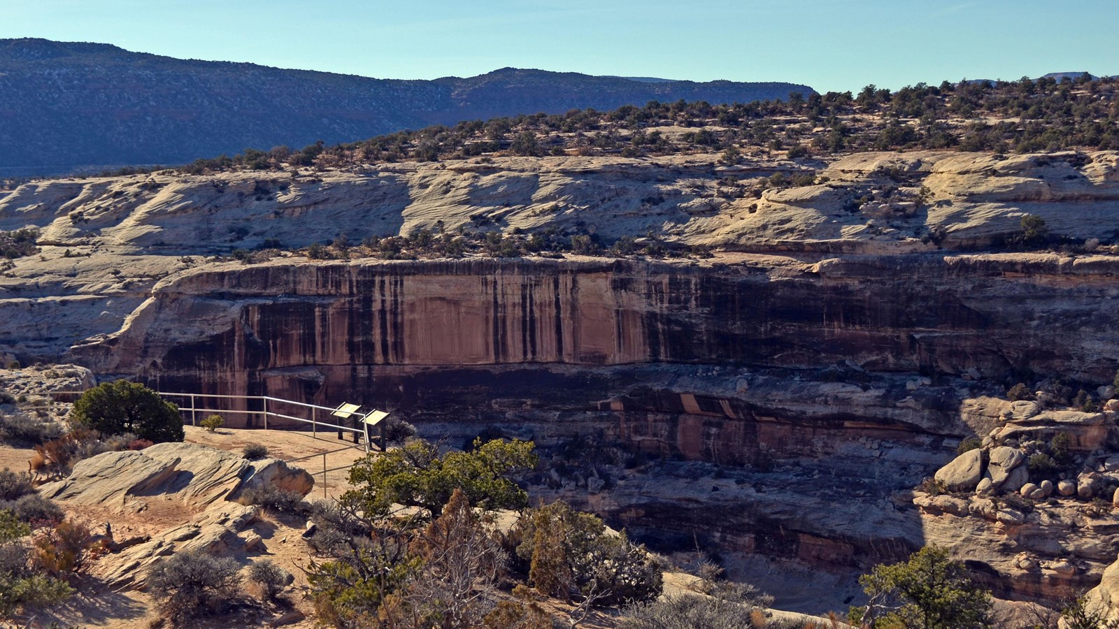 a viewing area on the cliff edge, with the canyon below