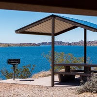 a picnic shelter next to a body of water