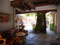 Looking down a corridor, into an open plaza.
