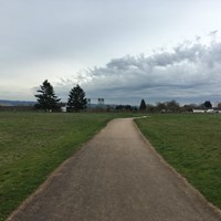 A paved trail leading towards Fort Vancouver.