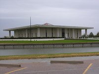 A rectangular building sitting in the middle of a lake