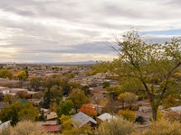 Looking out over a town of one to three story buildings with flat roofs.