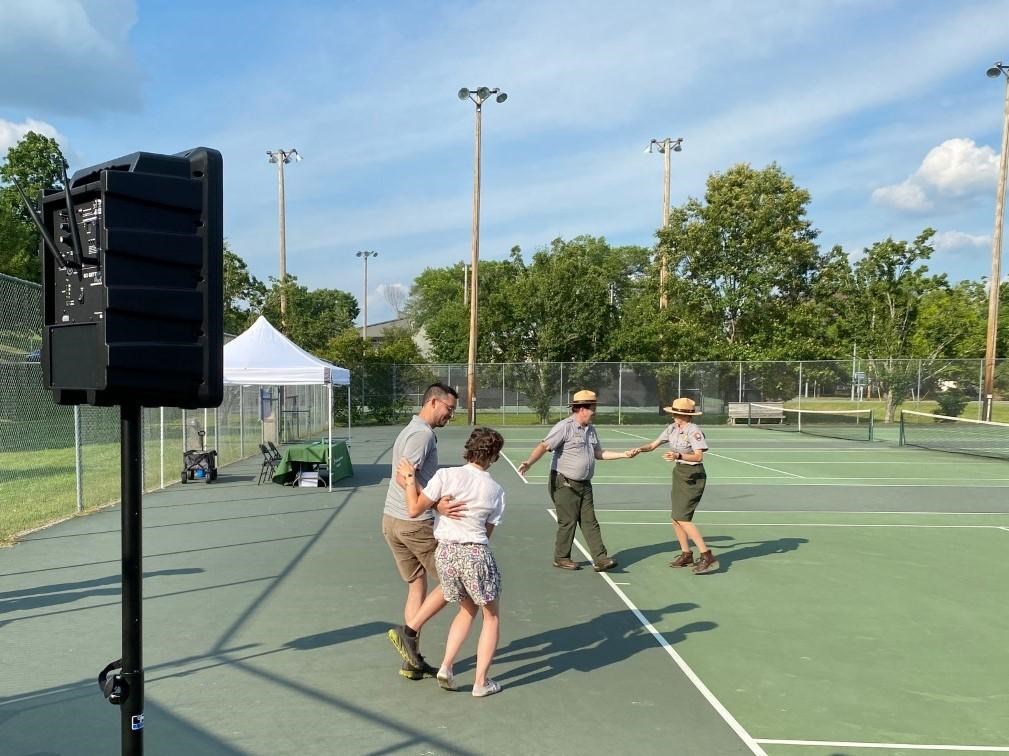 Dancers on a tennis court