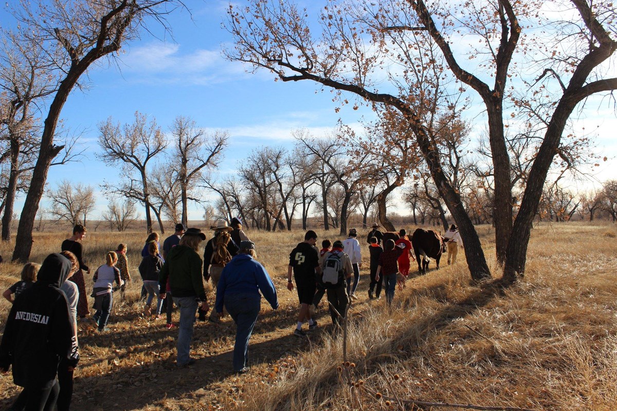 Visitors and living historians reach the Arkansas River bottom for a Yule Log.