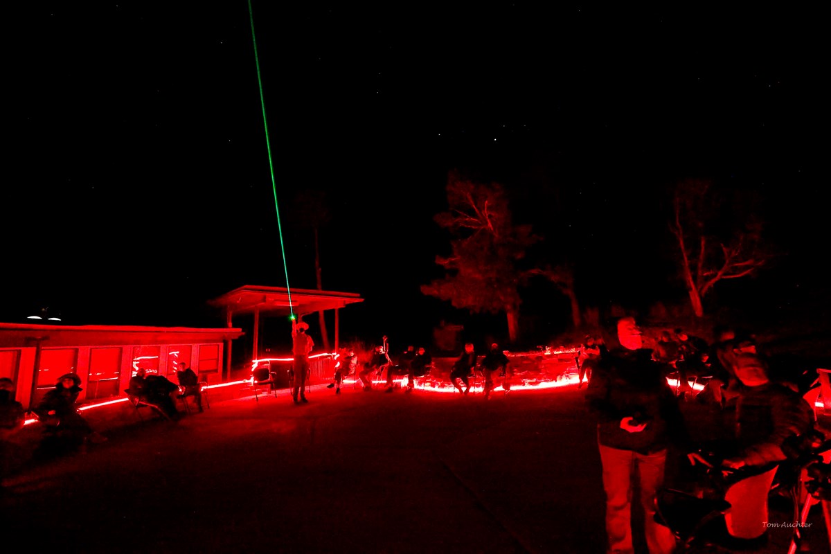 Ranger using green laser pointer to point out stars