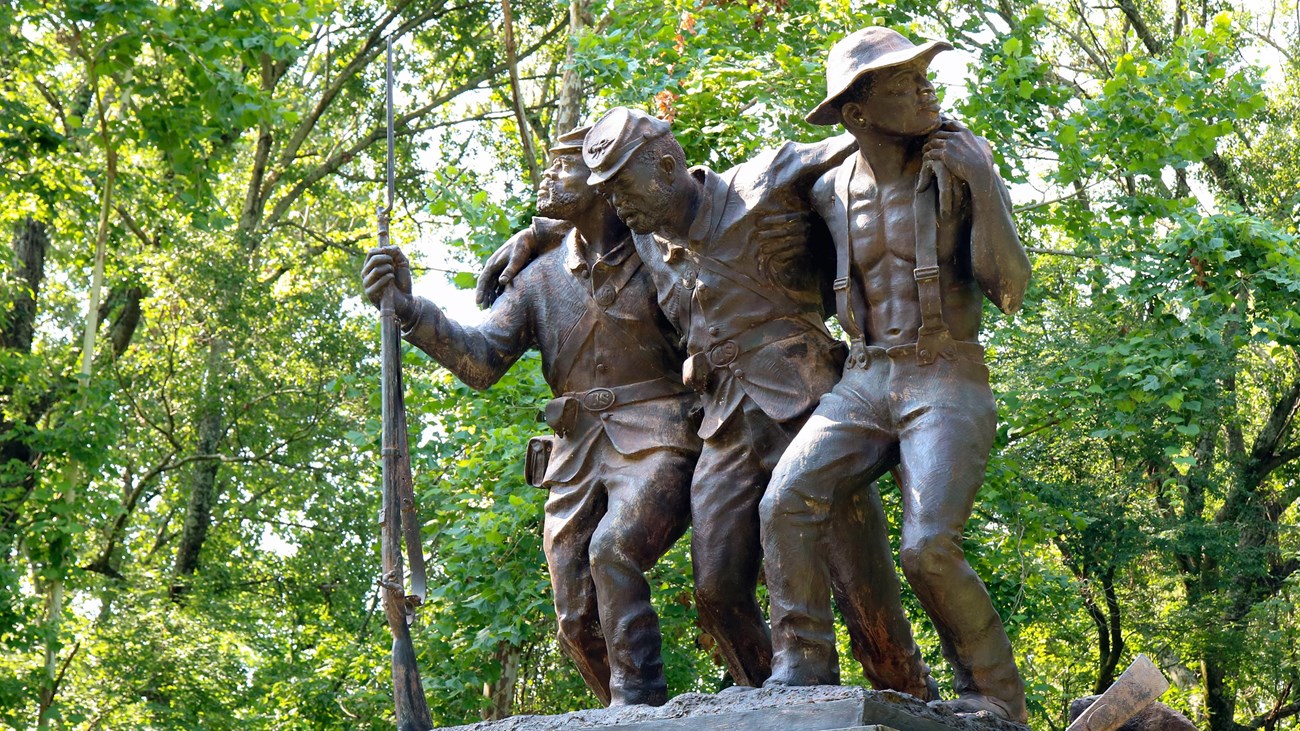 Statue of three Black men dressed in civil war soldier uniforms.