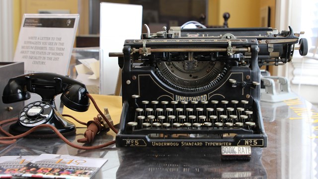 Old fashioned type writer and phone on a desk