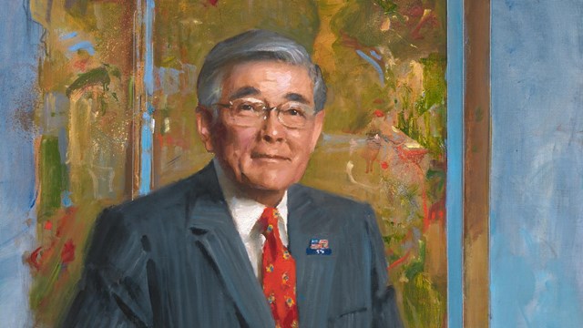 a portrait painting of a man in a gray suit and red tie in front of a colorful background