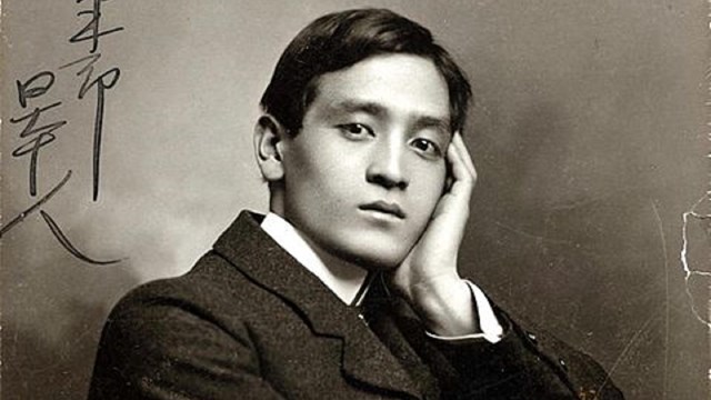 Black and white photo of Yone Noguchi, a Japanese poet, in 1903. He poses with hand on cheek.
