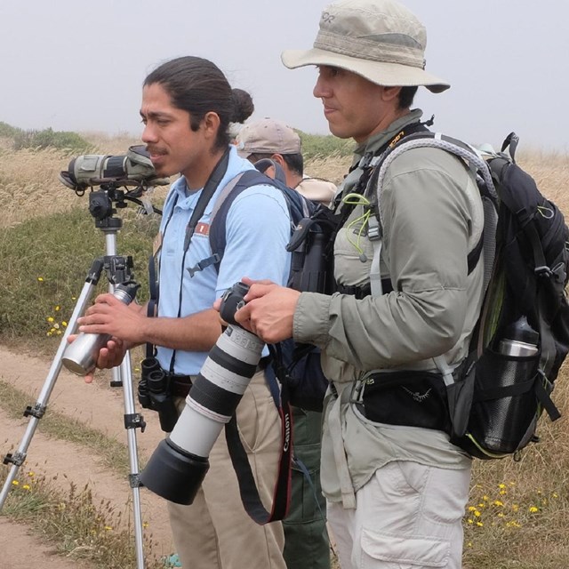 Intern giving a birding program in a wetland