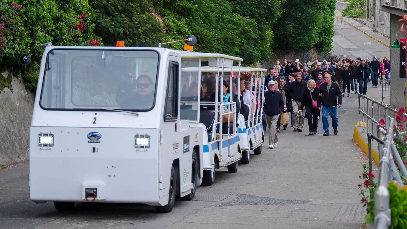 Tram carrying visitors up a steep slope. 