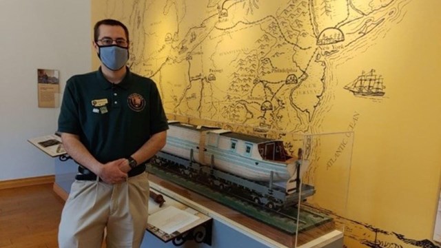 A volunteer standing in the Visitor Center.