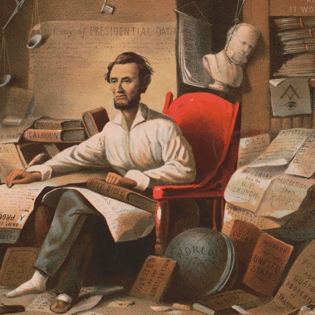 President Lincoln sitting at desk writing