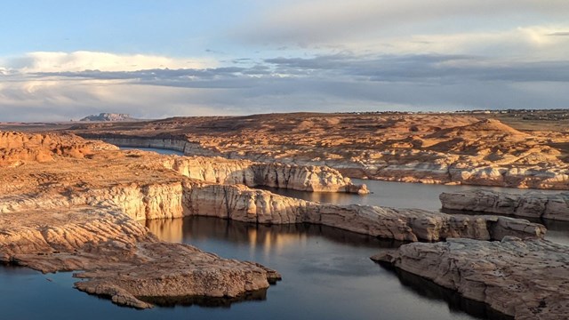 A lake surrounded by dry, desert ground.