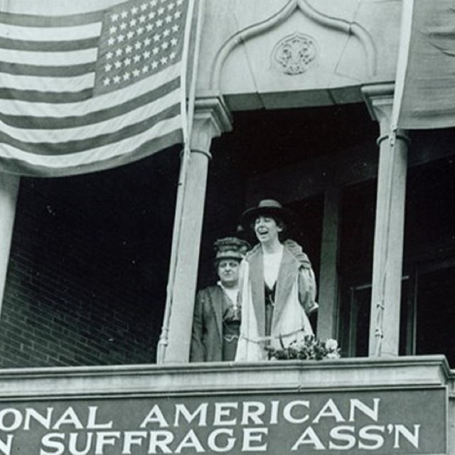 Two women standing on a balcony