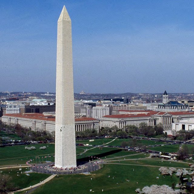 Color photo wide aerial shot of Washington Monument and surrounding area