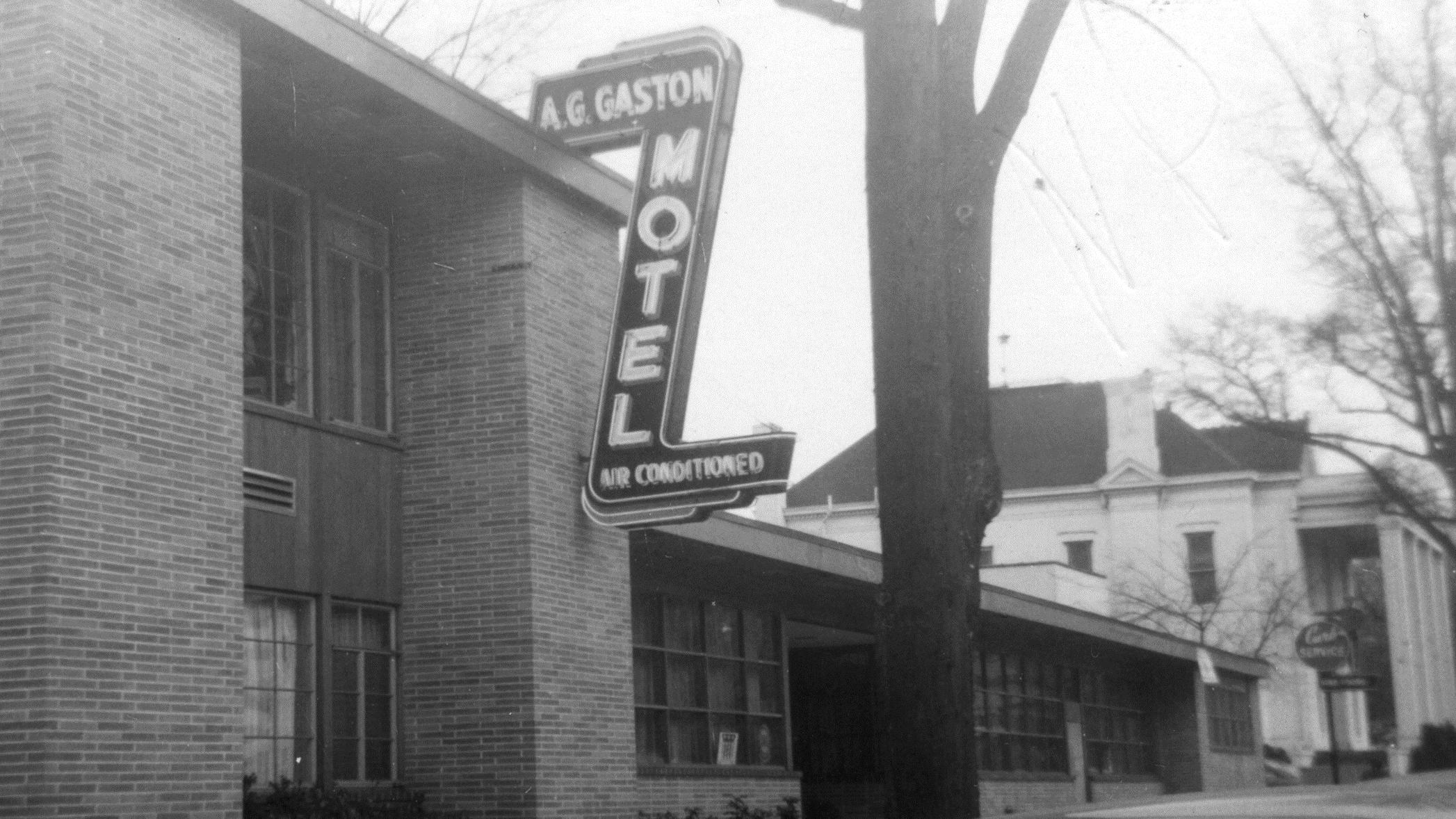 A "Z" shaped sign declaring A.G. Gaston Motel hangs from a brick and metal building