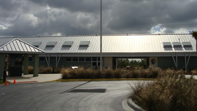 Visitor Center with American Flag and Park Service Arrowhead