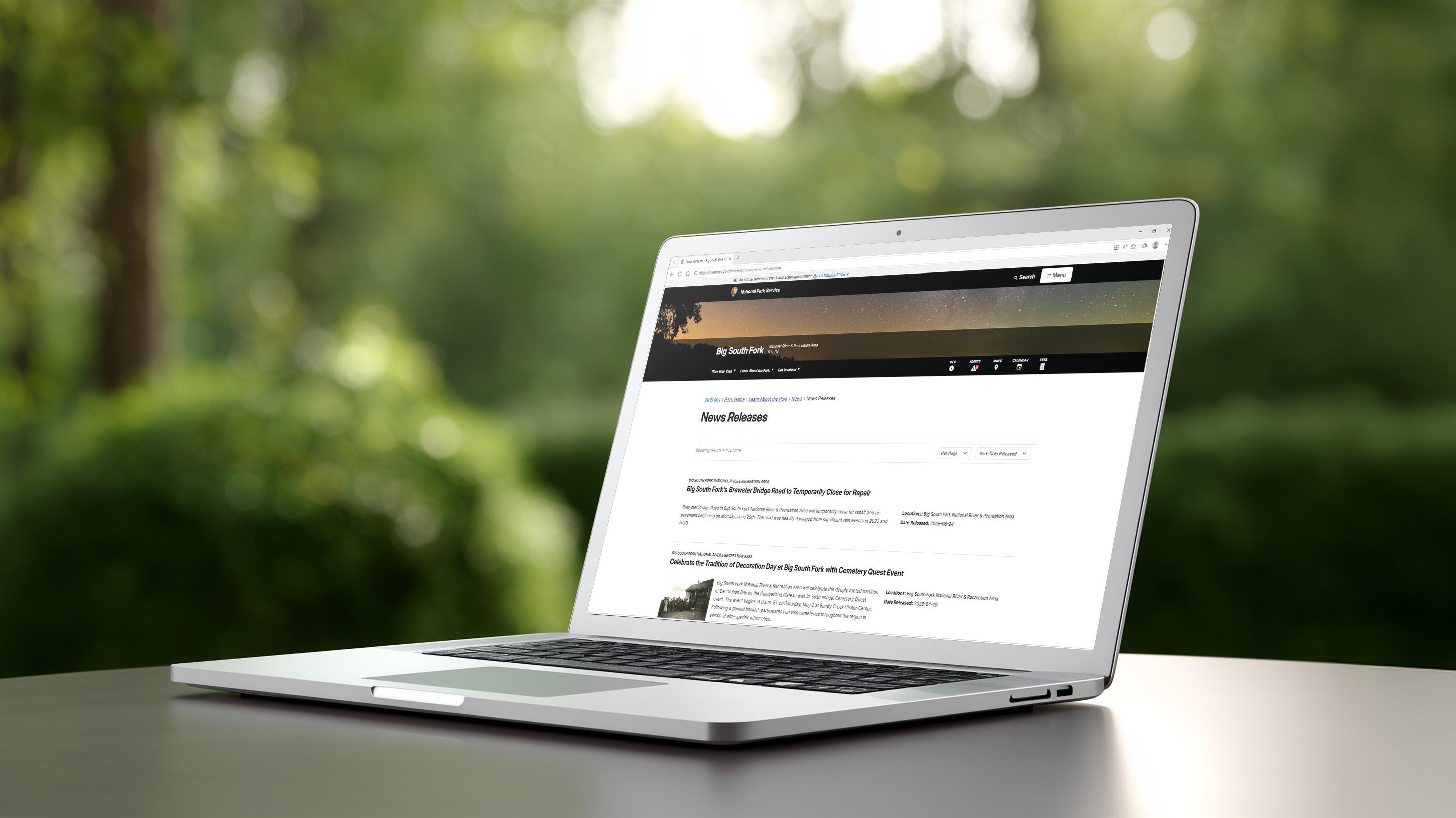 Laptop ontop of table showing news