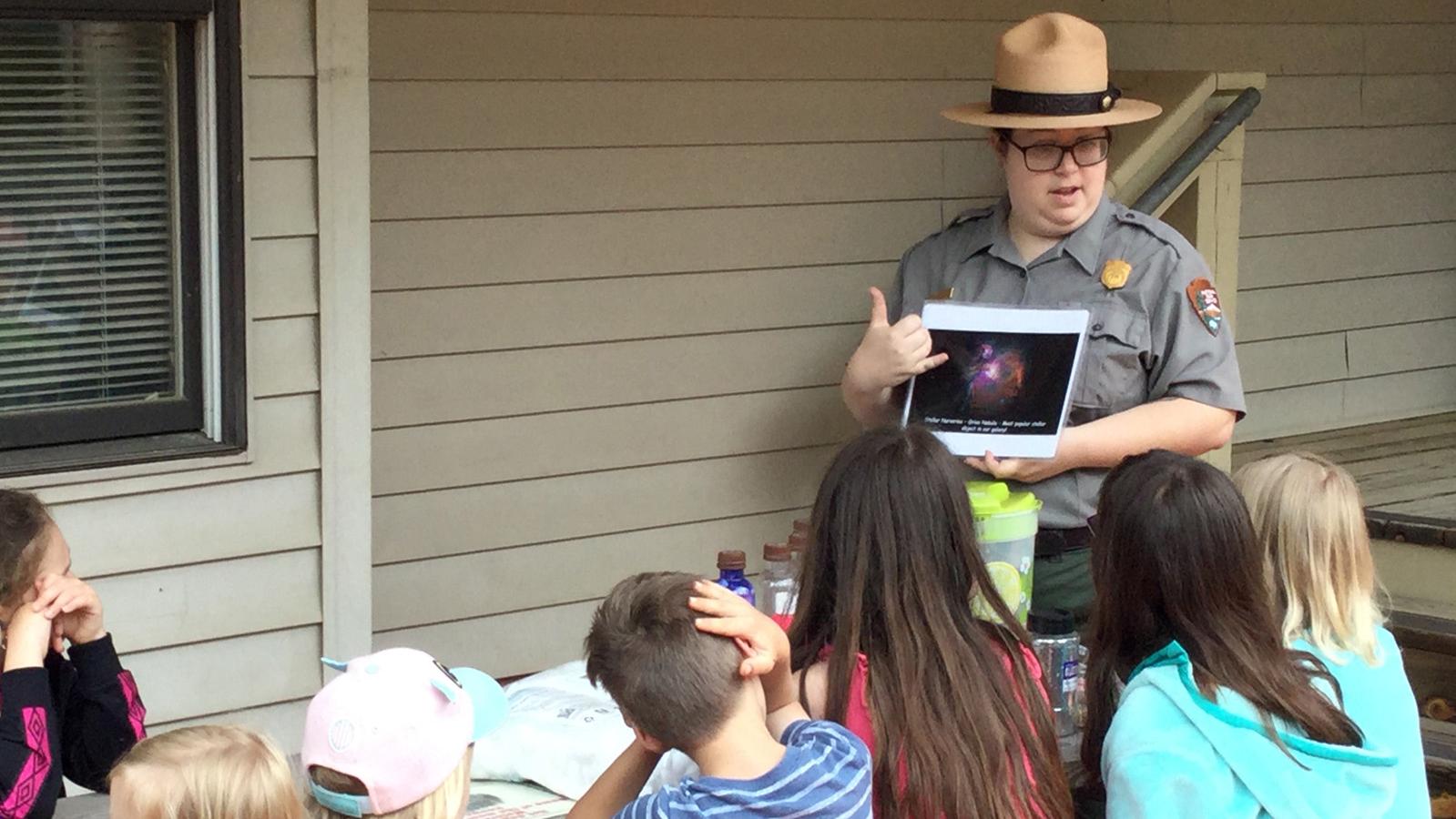 Kids around a ranger reading