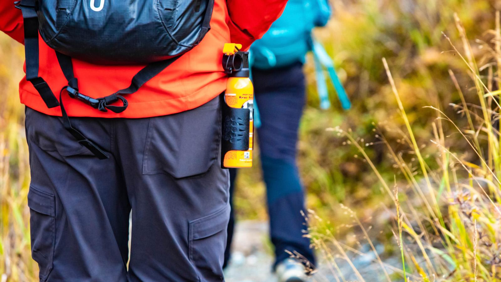 Hikers walking with bear spray on waist