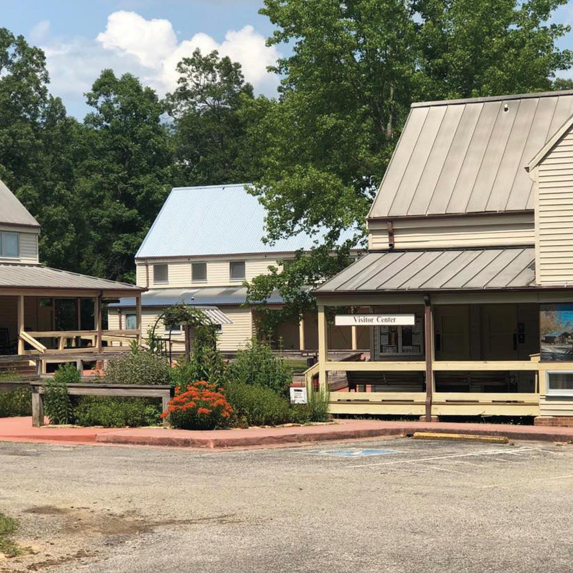 A group of buildings with a flower garden up front.